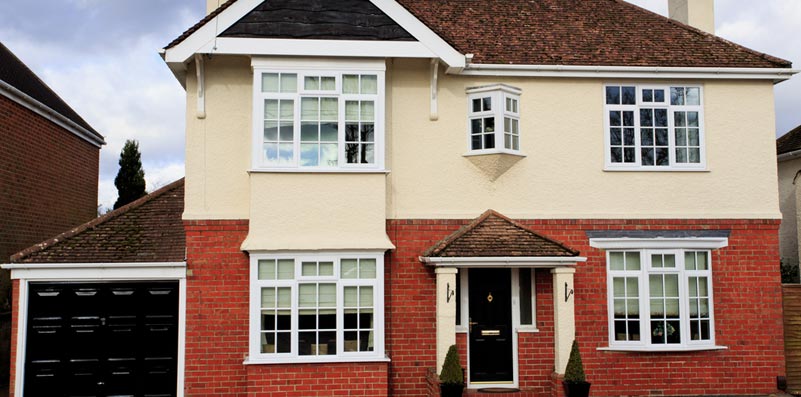 Full house with new white windows and black front door with archway