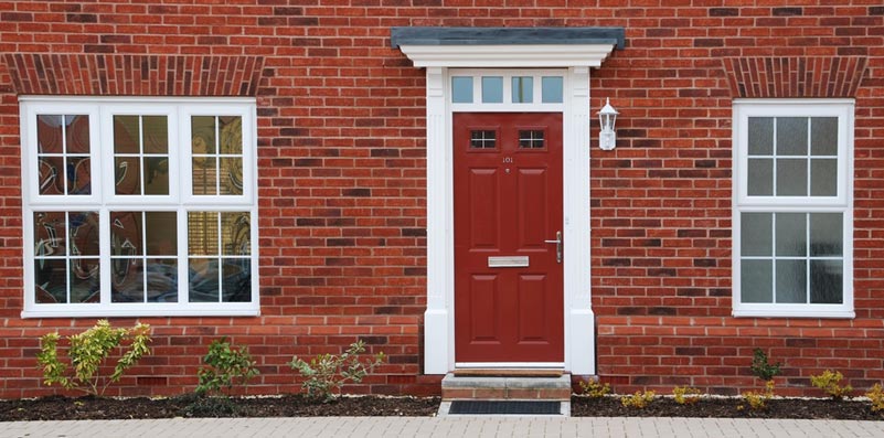 Red front door with white archway